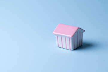 House ceramic on blue background, copy space.