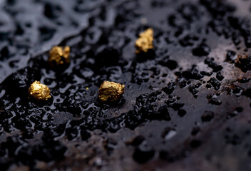 Closeup Gold on grungy wash pan with river sand. Gold digging discovery