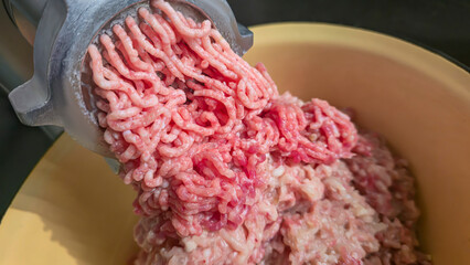 Meat grinder with fresh minced meat on the kitchen table Close-up of minced meat