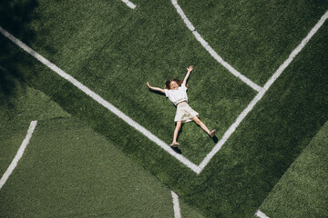 Child Relaxing on Sports Field