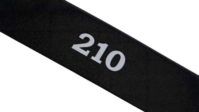 Number 210 printed on black fabric strip isolated on the transparent background, minimalist design for identification, sports, or industrial use
