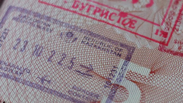 Horizontal 4K travel video. Close up part of pages of Russian foreign passport with visas, border stamps, permits to enter countries. Tourist document. Concept of tourism, visit, trip, voyage, flight
