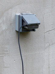 A grey box with a black cord coming out of it