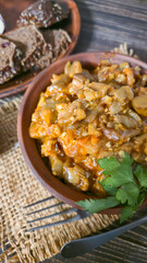 Stew of eggplant, pepper, onion and carrot. Home cooking. In a warm plate,