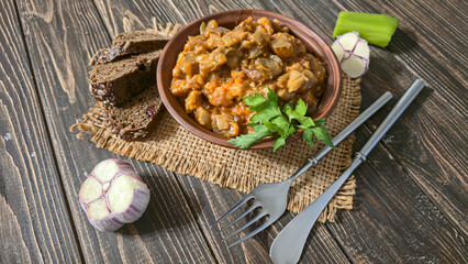 Stew of eggplant, pepper, onion and carrot. Home cooking. In a warm plate,