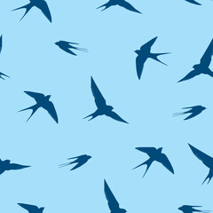 Fototapeta premium Vector seamless pattern with silhouettes of swallows soaring in the sky