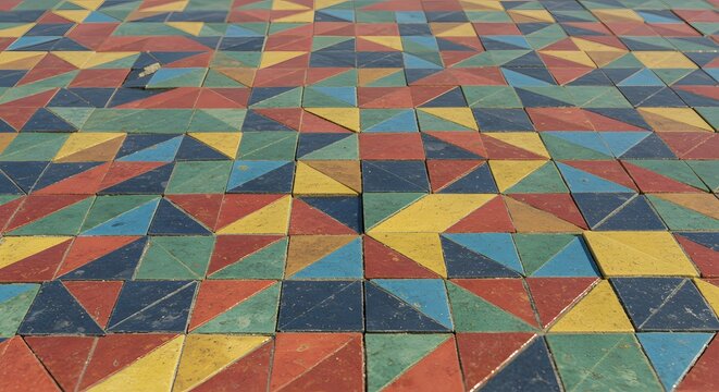 Colorful geometric pattern made of triangular and square tiles in shades of blue, green, yellow, red, and black.