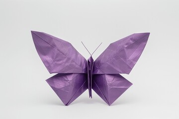 Elegant purple origami butterfly showcasing intricate folding techniques in a minimalist setting