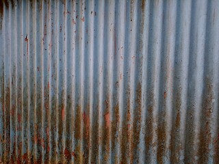 old rusty metal roof texture background. Rusted galvanized iron plate, red stain on old metal sheet wall texture. strip zinc wall background texture.