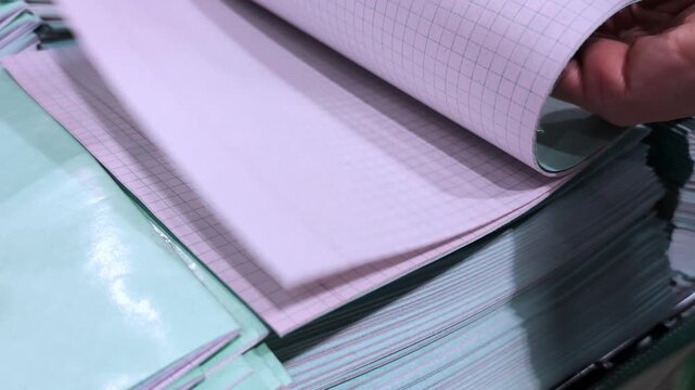 Exploring the process of selecting high-quality graph paper in a bustling stationery store during a busy afternoon