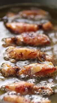 Fried dried cuttlefish (Beka squid) in boiling oil. Close-up shot