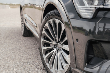 Premium electric SUV in gray with black chrome trim and large wheels.
