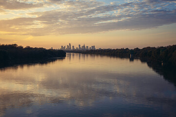 Vistula River and city downtown in Warsaw, capital of Poland during sunset seen from Siekierkowski bridge