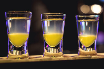 A few vodka shots on a counter in the bar