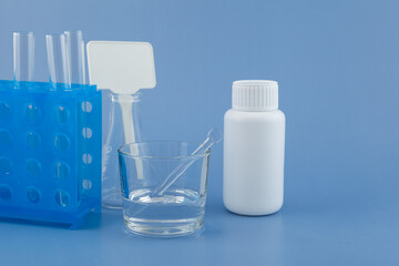 Polydimethylsiloxane PDMS in glass dish. Food additive E900. Dimethylpolysiloxane or dimethicone is known for its unusual rheological (or flow) properties. Silicone oil, polymerized siloxane