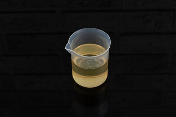 Polysorbate 80 in measuring cup. Polyoxyethylene (20) sorbitan monooleate widely used in food, cosmetic, pharmaceutical, and industrial sectors. Other names: E433, Tween 80, PEG-20 or Oleic acid
