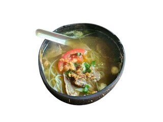 Hot Indonesian-style beef soup with tomatoes and vegetables in a dark bowl, placed on white surface, highlighting Southeast Asian culinary presentation