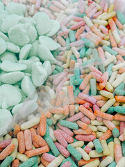 Colorful assortment of sweet candies displayed in bulk at a market on a sunny day