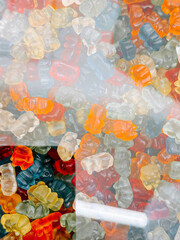 Colorful gummy bears displayed in a variety of shapes and colors at a candy shop