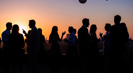 Fototapeta premium Silhouette of people chatting at a party