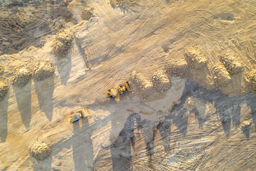 machinery and earthworks on a construction project, aerial top down view