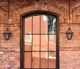 Vintage Brick Wall with Arched Window and Gas Lanterns