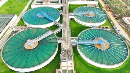 Aerial drone view of a wastewater treatment plant showing large clarifiers and filtration tanks, highlighting advanced infrastructure for sustainable water management and environmental protection.

