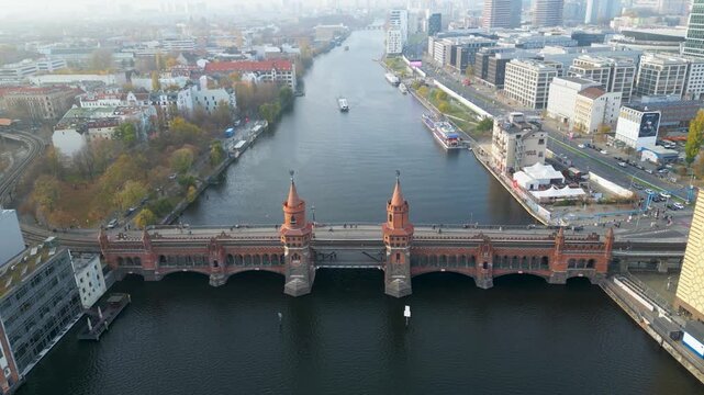 Aerial view of the majestic brick Oberbaum Bridge over the Spree River, a historic landmark connecting vibrant districts, Berlin, Berlin, Germany.