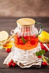 Hawthorn tea with mint leaves, honey and lemon in a glass  cup on the table. Vitamin health drink.