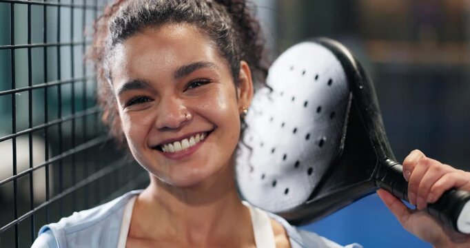 Face, woman and racket for padel tennis on court, sports training and competition at club. Portrait, female person and laughing for fitness, game performance and match practice for tournament event