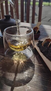 Chinese tea, making tea in a traditional, in a small cups and teapot over dark background