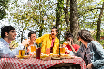 Friends group drinking eer at brewery bar restaurant – food and beverage concept with happy people enjoying time together having genuine fun at cool pub venue  