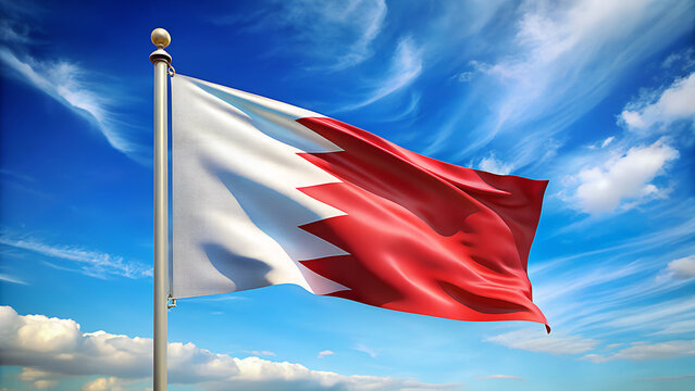 The national flag of the kingdom of bahrain proudly waving in the bright blue sky with wispy white clouds on a sunny day