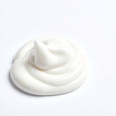 A smooth, luscious white cream sits atop a rustic wooden table, glistening softly under warm ambient light, inviting indulgence and delight.