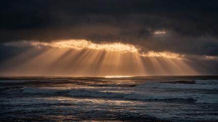 Coastal Sunbeams: Dramatic ocean view featuring golden rays piercing through storm clouds, illuminating the sea and waves below.