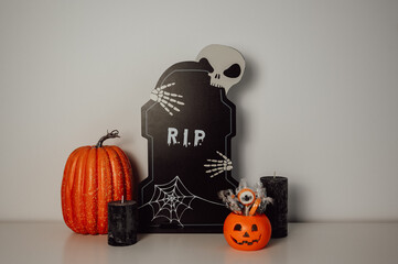 Moody halloween banner with candles, candies, pumpkins and other decorations 