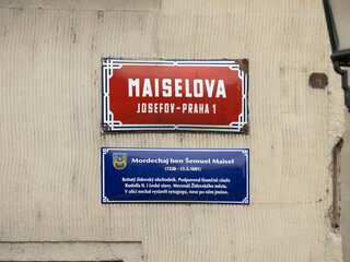 Maiselova street sign in Josefov Praha 1 in Prague, Czechia. Red colored road signage of the location in the so called Jewish Town. Information about the person Mordechaj ben &Scaron;emuel Maisel.