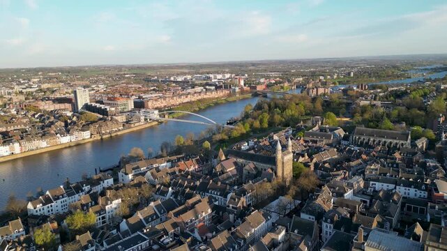 Aerial view of the Maaspromenade and bridge over the river, with the city's architecture creating a beautiful contrast, Maastricht, Netherlands.