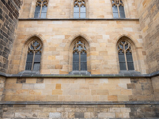 Gothic architecture details at the facade of a cathedral. Window arch out of sandstone material. Beautiful shapes as decoration of the old medieval church exterior.