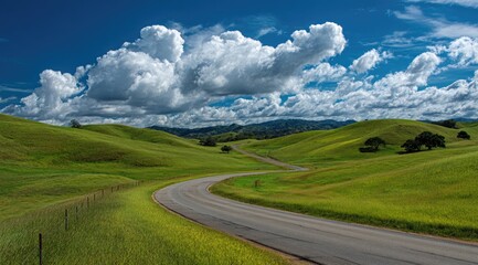 Winding road through rolling green hills under a vibrant blue sky with puffy white clouds