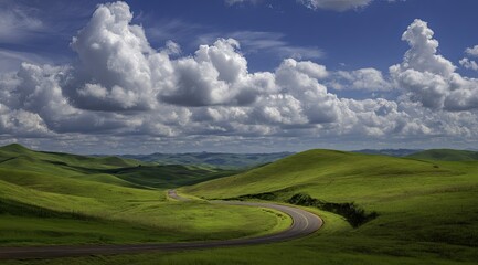 Scenic winding road through rolling green hills under a partly cloudy sky