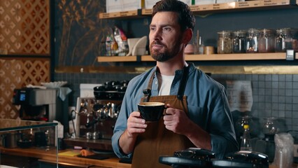 Cheerful Caucasian guy barista male gesturing smiling man waving hand in restaurant bartender greeting symbol small business worker waiter serving carefree employee hold coffee mug order cafe service