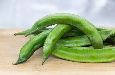Close up of a wooden crate filled with broad beans,