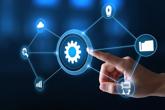 Human hand pressing a glowing gear icon with connected application features demonstrating automation and digital technology solutions - Powered by Adobe