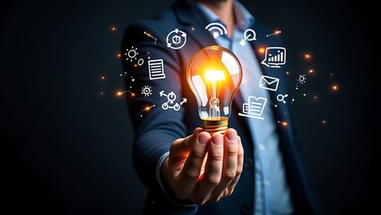 Man holding a glowing light bulb representing innovation and new ideas surrounded by technology icons for business growth and strategy