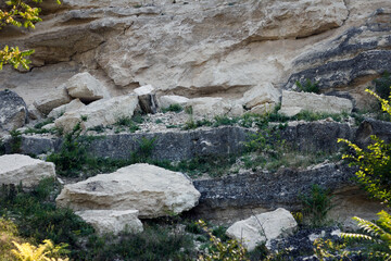 Rocky terrain with large boulders and patches of green grass