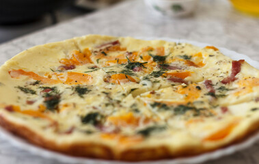 A a savory omelette with orange tomatoes, bell peppers, herbs, and pieces of ham
