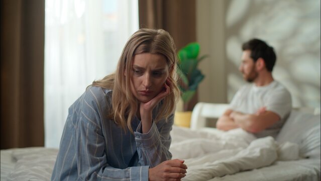 Family argument stressed Caucasian couple in bedroom divorce frustrated husband ignore sad worried woman wife relationship psychological problem breakup pair quarrel arguing morning man avoid speaking