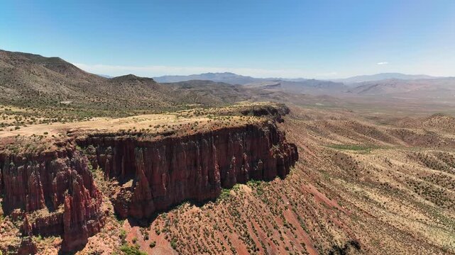 Aerial view of the rugged landscape with Armer Mountain and the Upper Salt River, showcasing contrasting red rock formations against the arid terrain, Tonto Basin, AZ, United States.