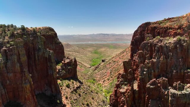 Aerial view of the majestic Armer Mountain and the serene Salt River, a contrast of red rock and green vegetation, Tonto Basin, AZ, United States.